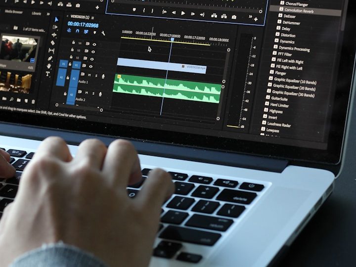 Structured Work Experience Hands editing audio waveforms on a laptop screen using editing software.